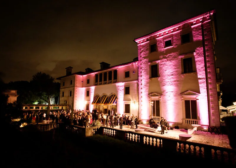 Fachada iluminada do Vizcaya Museum and Gardens durante uma apresentação musical à noite